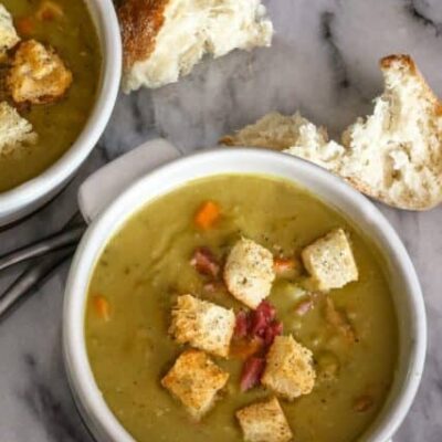 bowls of split pea soup and croutons