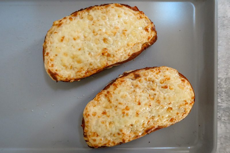croque monsieur sandwich prep: the finished baked sandwich with browned cheesy topping