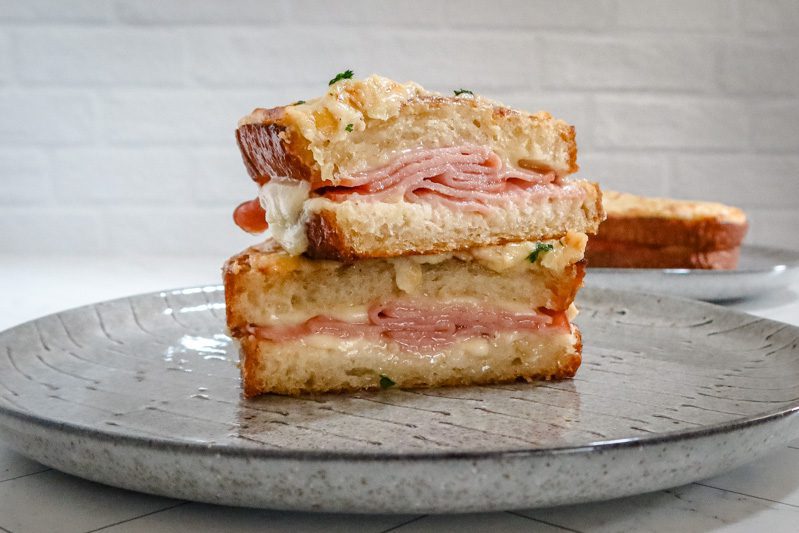 another closeup of the croque monsieur showing the cheese and ham filling.