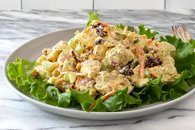 Dressing for curried chicken salad is combined in a bowl.