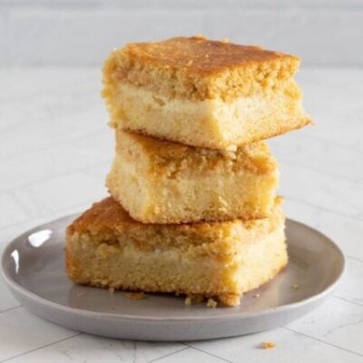 custard cornbread stacked on a plate