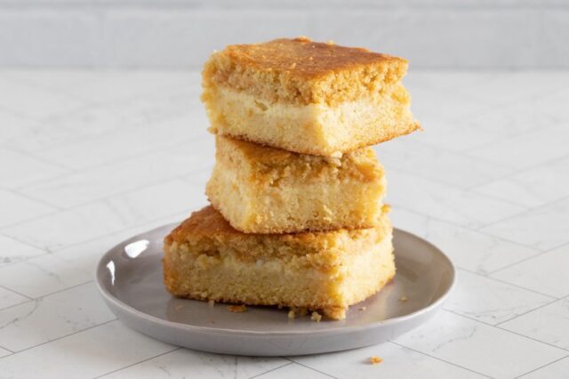 custard cornbread stacked on a plate