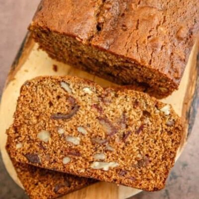 date nut bread on a wood slab, sliced