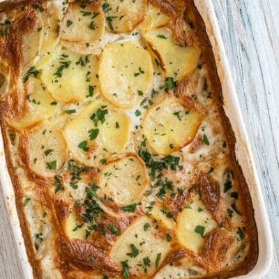 Hearty potato casserole topped with herbs and cheese.