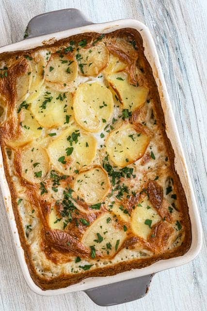 Hearty potato casserole topped with herbs and cheese.