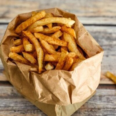 deep fried french fries in a paper bag