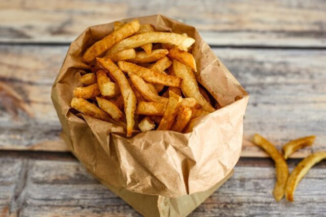 deep fried french fries in a paper bag