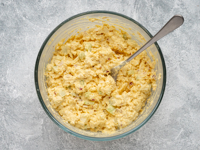 Egg salad preparations with mayo and vegetables.