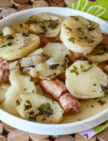 A plate of dublin coddle, potatoes and sausages