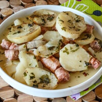 A plate of dublin coddle, potatoes and sausages