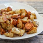 roasted potatoes with garlic on a serving plate