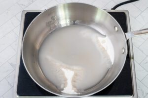 Making caramel sauce in a saucepan.