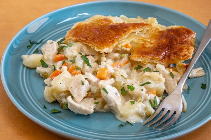 chicken pot pie with puff pastry patchwork crust on a plate
