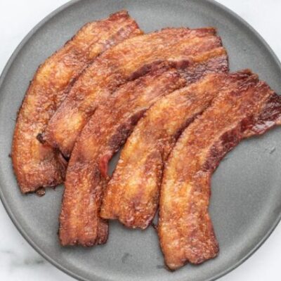 A plate of baked bacon.