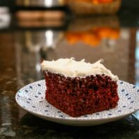 A slice of easy cake mix red velvet cake on a plate.