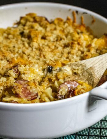 Farfalle, sausage, and cheese casserole in a baking dish.