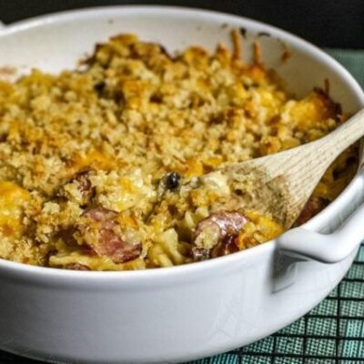Farfalle, sausage, and cheese casserole in a baking dish.