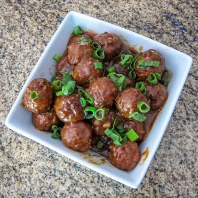 slow cooker meatballs with asian flavors in a serving bowl