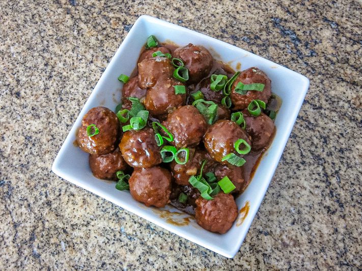 slow cooker meatballs with asian flavors in a serving bowl