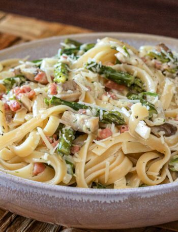 fettuccine with ham and asparagus in a bowl