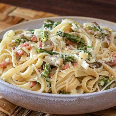 fettuccine with ham and asparagus in a bowl