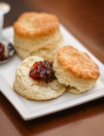 flaky buttermilk biscuits on a plate with jam