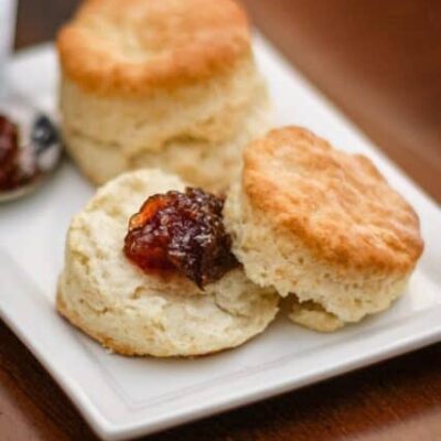 flaky buttermilk biscuits on a plate with jam