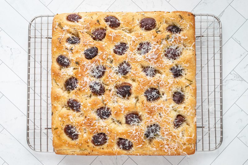 olive focaccia baked on a cooling rack