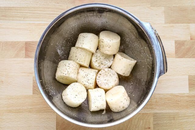 Creamy cubed potatoes in a metal bowl.