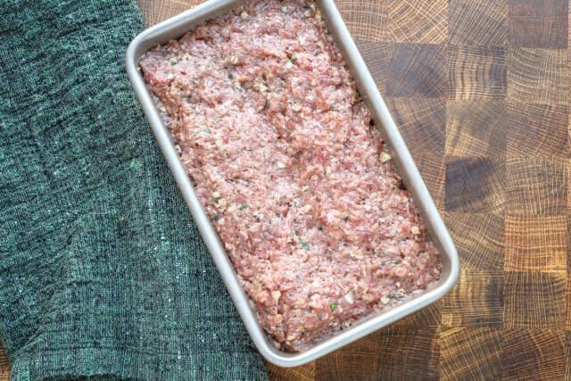 Raw meatloaf mixture in a rectangular baking dish.
