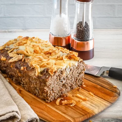Golden-brown meatloaf with crispy fried onion topping.