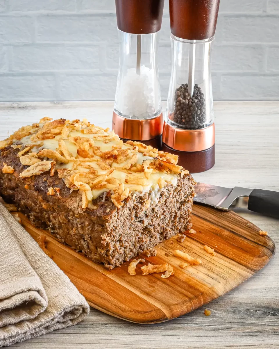 Golden-brown meatloaf with crispy fried onion topping.