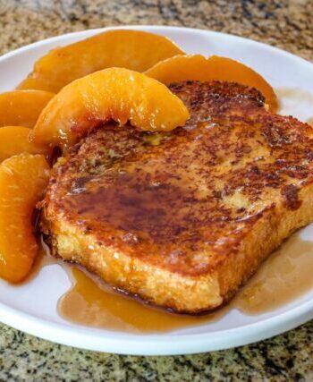 french toast on a plate with caramelized peaches