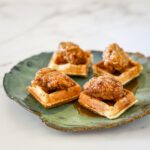 fried chicken served on waffle pieces as a snack.