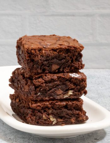 fudgy brownies stacked on a small plate