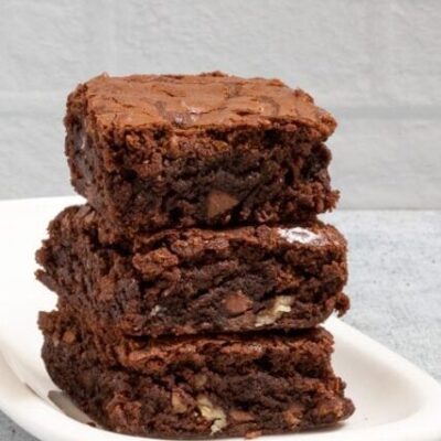 fudgy brownies stacked on a small plate