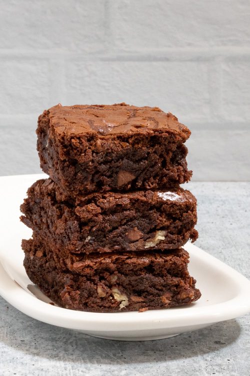 fudgy brownies stacked on a small plate