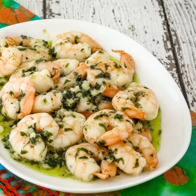 Boiled shrimp garnished with chopped herbs and garlic.