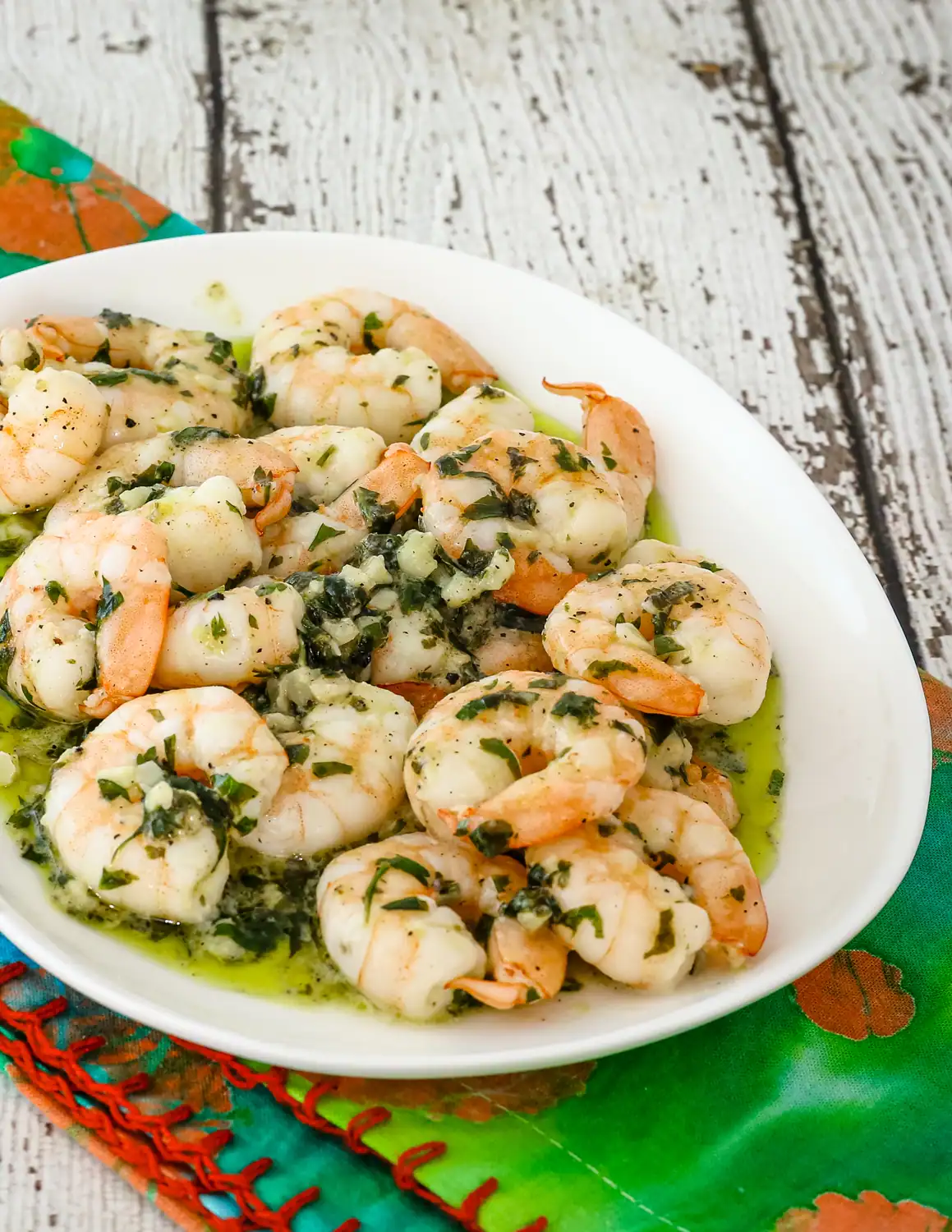 Boiled shrimp garnished with chopped herbs and garlic.