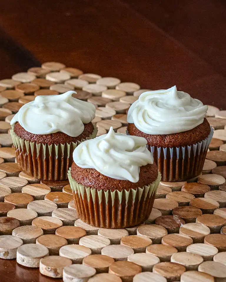 Rich chocolate cupcakes topped with creamy vanilla frosting.