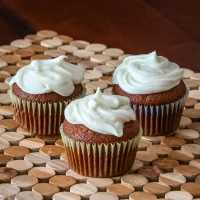 Delicious cupcakes topped with swirls of creamy white frosting.