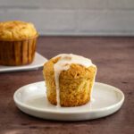 A gluten free pineapple muffin with some icing drizzled over it