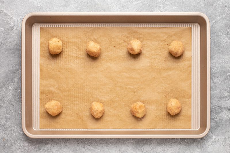 gluten free snickerdoodles unbaked on a baking sheet