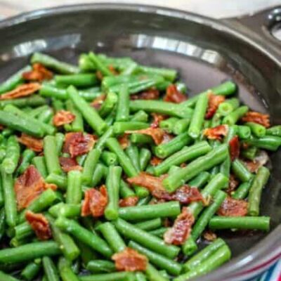 green beans with bacon in in a DVF serving dish