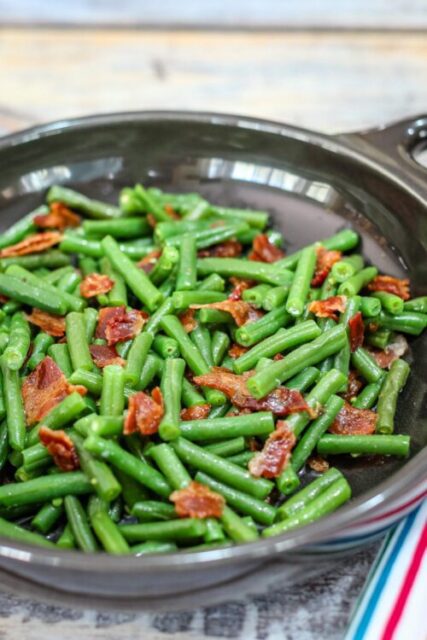 green beans with bacon in in a DVF serving dish