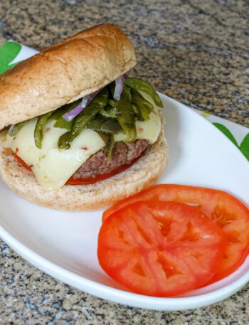 chile pepper burgers with sliced tomatoes on a plate