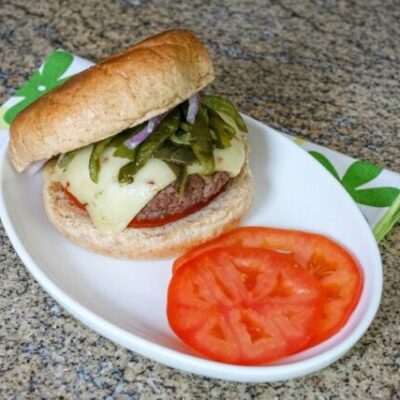 chile pepper burgers with sliced tomatoes on a plate