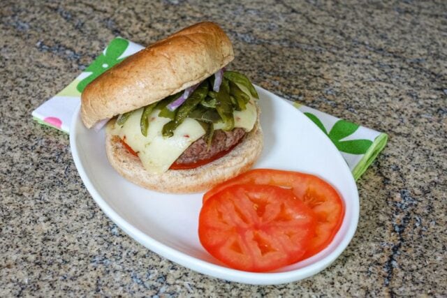 chile pepper burgers with sliced tomatoes on a plate