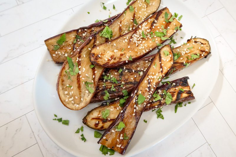 another view  of the grilled chinese eggplant on a serving plate