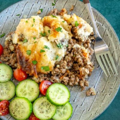 Baked meat casserole with mashed potatoes and cheese on top.